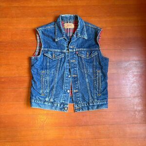 Vintage Levi’s denim trucker vest with flannel lining Made in USA. Size M.